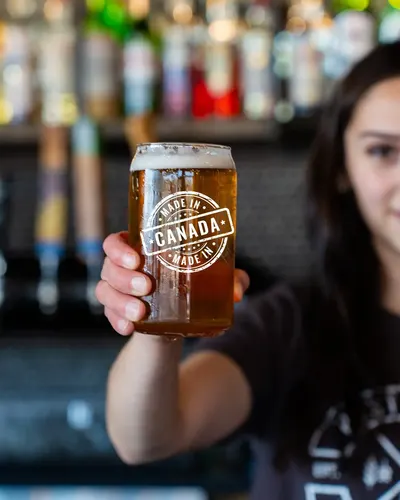 A pint glass with a Canada crest raised in the taproom