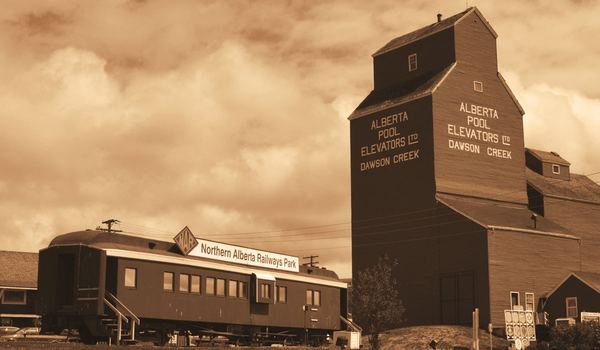Sepia photo of the Alberta Pool grain elevator and a railway car in Dawson Creek